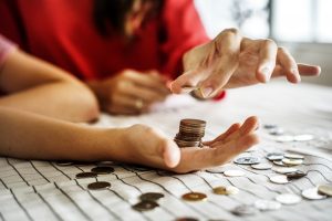 A woman in red counting coins