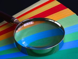 Magnifying Glass On Top of Colored Paper