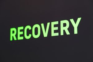 The word recovery in neon green