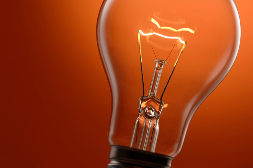 Light Bulb In Orange Background