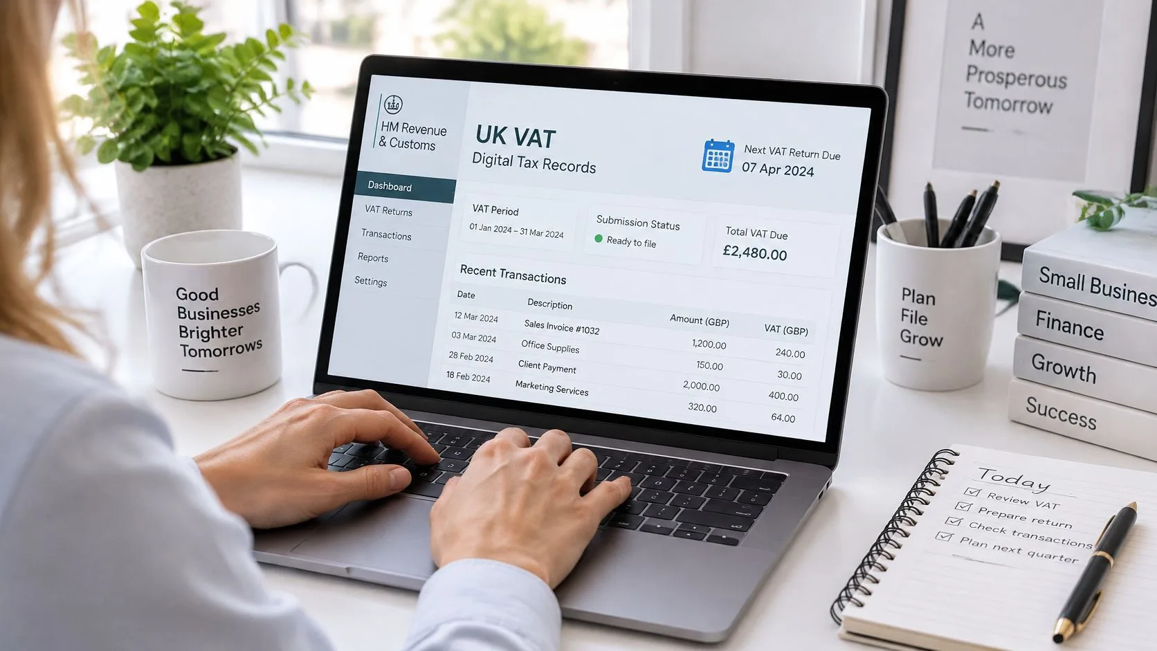 A person using a laptop to view digital UK VAT tax records for their small business accounting.
