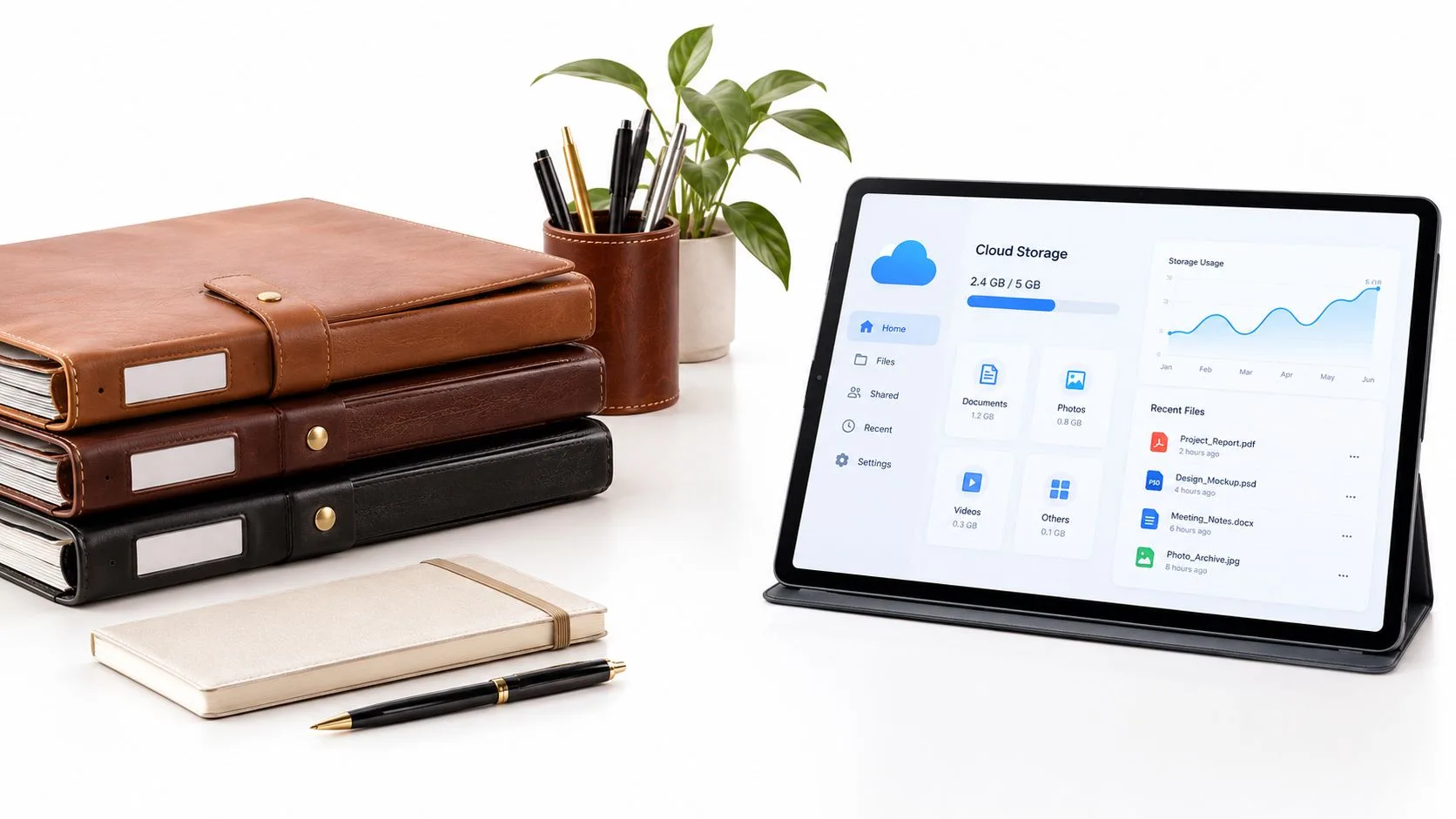A modern desk workspace with notebooks, a digital tablet displaying cloud storage statistics, and a pen.